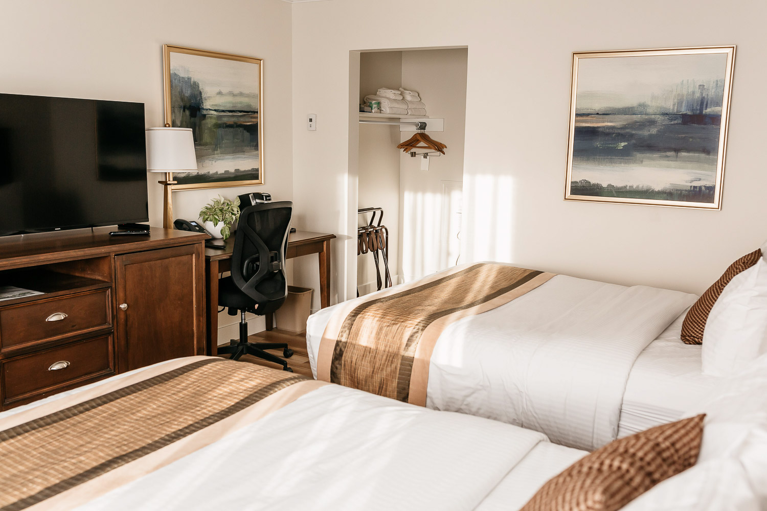 A view of the desk and beds in the Queen Room
